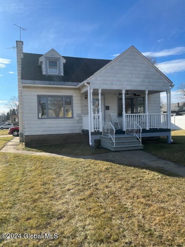 view of front of house with a porch and a front yard