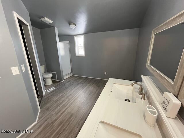 bathroom featuring hardwood / wood-style floors, vanity, and toilet