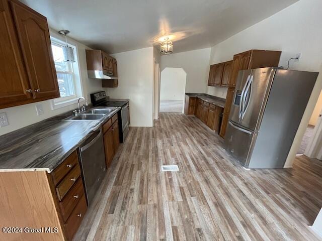 kitchen featuring light wood-type flooring, sink, and appliances with stainless steel finishes