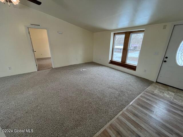 entryway with ceiling fan, hardwood / wood-style floors, and lofted ceiling