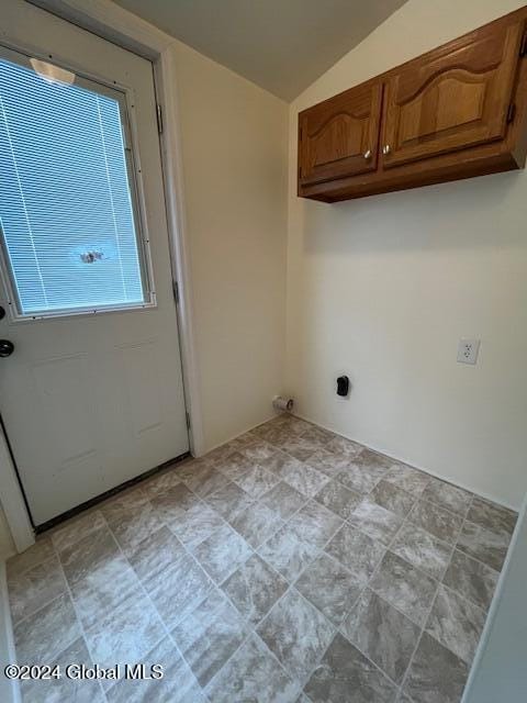 laundry area featuring cabinets