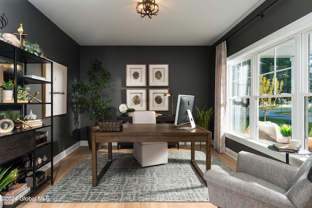 office space with baseboards and wood finished floors