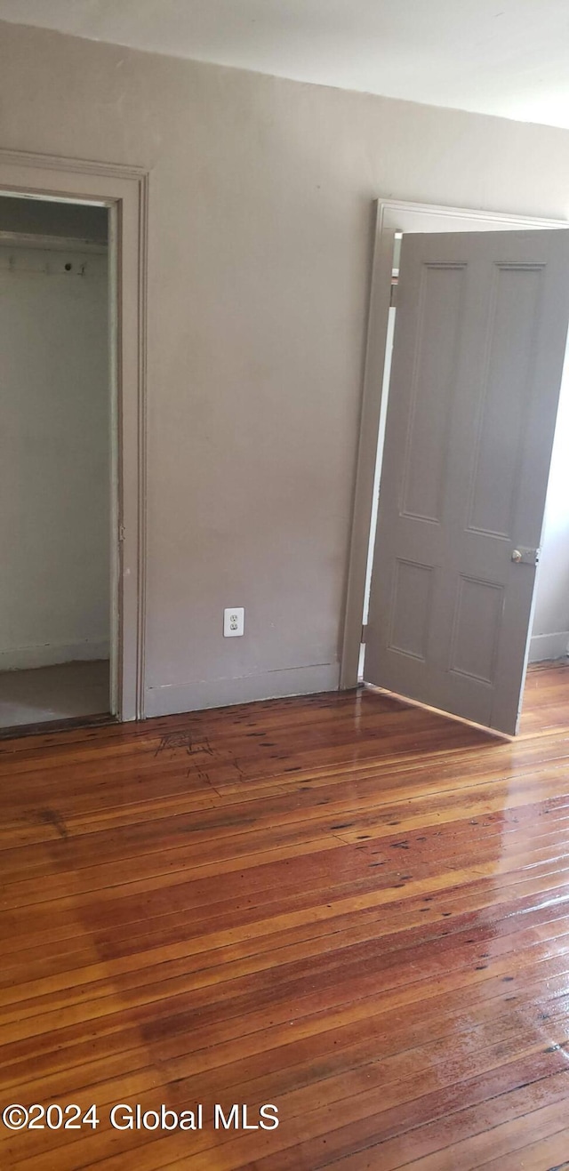 unfurnished bedroom featuring hardwood / wood-style flooring