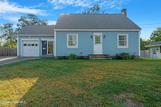 view of front of property with a front yard and a garage