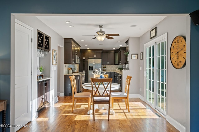 dining area featuring ceiling fan, light hardwood / wood-style flooring, and sink