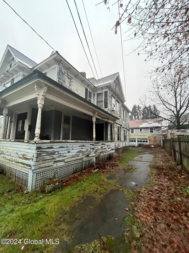 view of side of home with a porch