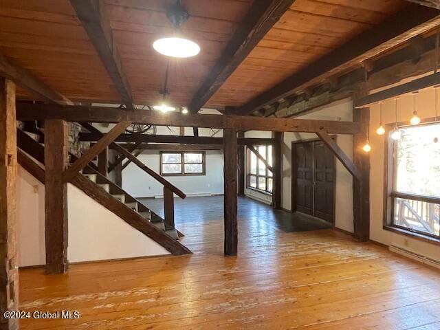 basement with wooden ceiling, plenty of natural light, and wood-type flooring