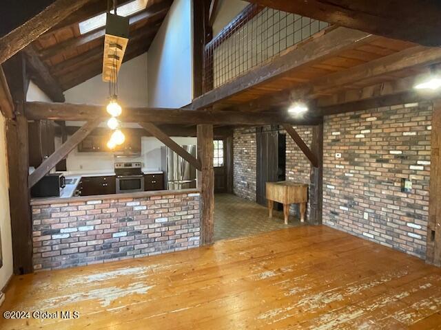 bar featuring hardwood / wood-style flooring, lofted ceiling with beams, wooden ceiling, and appliances with stainless steel finishes