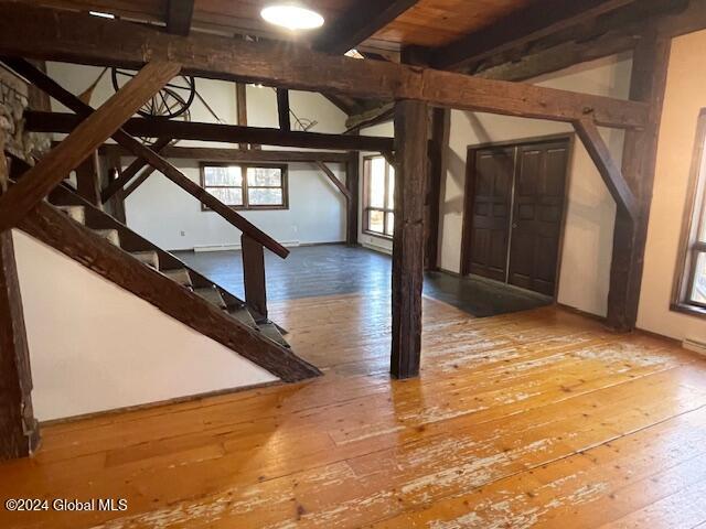 bonus room featuring hardwood / wood-style floors, beam ceiling, and wood ceiling