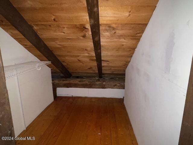 additional living space with vaulted ceiling with beams, wooden ceiling, and hardwood / wood-style flooring