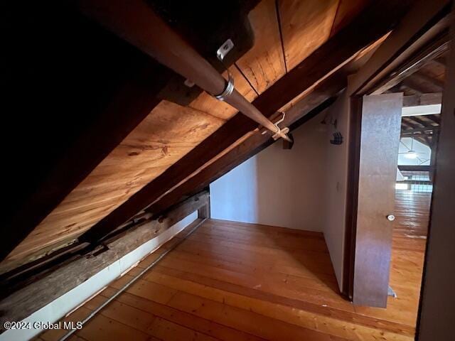 bonus room with beam ceiling, light hardwood / wood-style floors, and wood ceiling