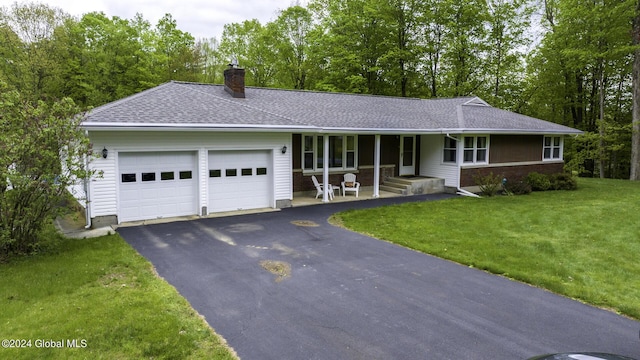 single story home with a front yard and a garage