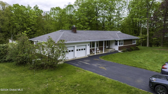 single story home featuring a garage and a front yard