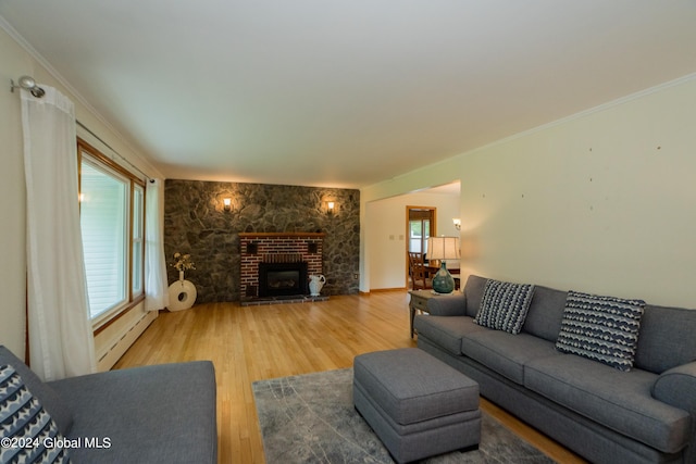 living room featuring baseboard heating, ornamental molding, and hardwood / wood-style flooring