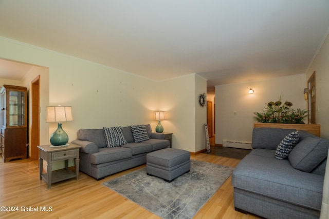 living room with hardwood / wood-style flooring, crown molding, and a baseboard heating unit