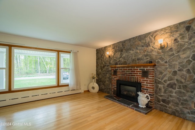 unfurnished living room featuring light hardwood / wood-style floors and baseboard heating