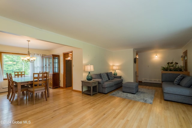 living room featuring a chandelier, light hardwood / wood-style floors, a baseboard radiator, and ornamental molding