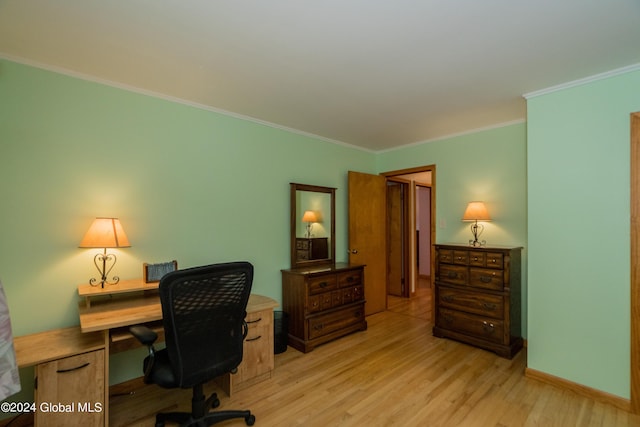 office with light hardwood / wood-style floors and ornamental molding