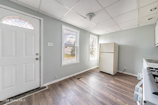 foyer featuring hardwood / wood-style flooring and a drop ceiling