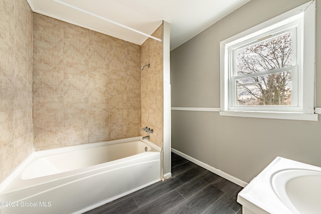 bathroom featuring vanity and tiled shower / bath