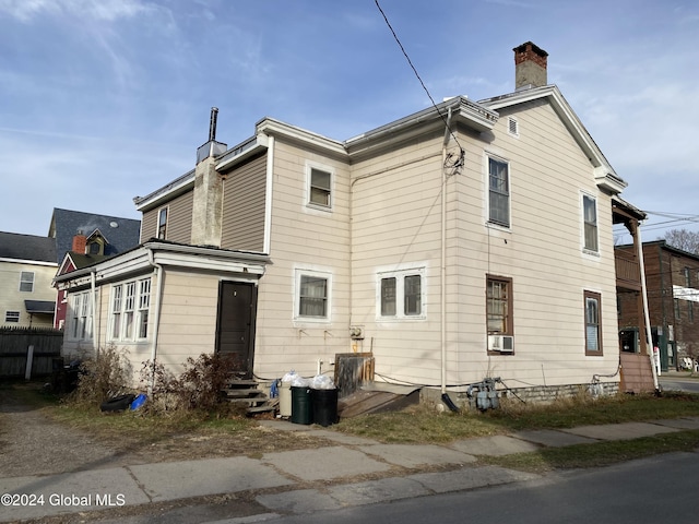 rear view of house with cooling unit