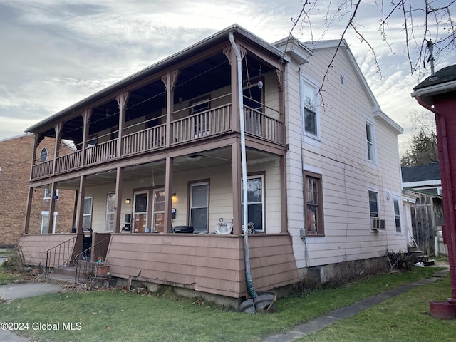 view of front of home featuring covered porch, a front lawn, a balcony, and cooling unit