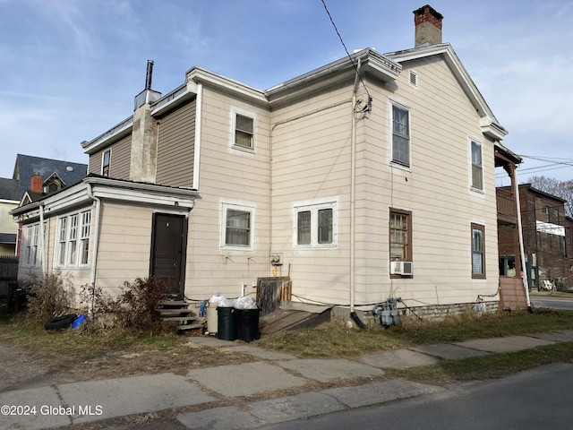 rear view of house featuring cooling unit