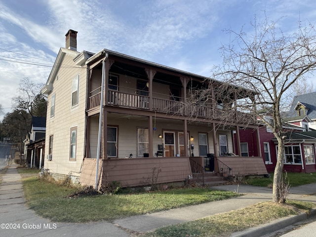 view of front of home with a porch and a balcony