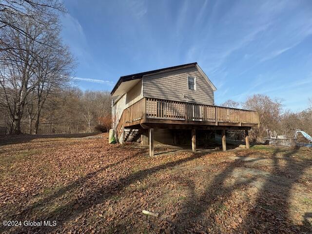 back of property featuring a wooden deck