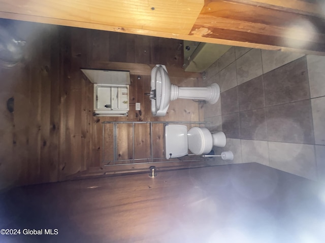 bathroom featuring wooden walls