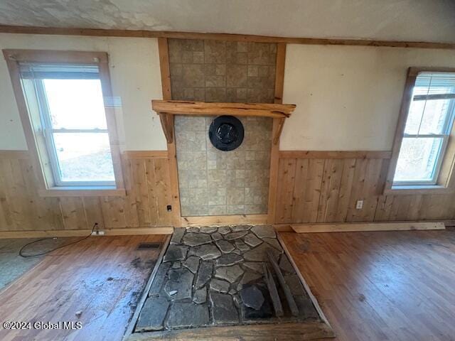 interior space with wood-type flooring and wood walls