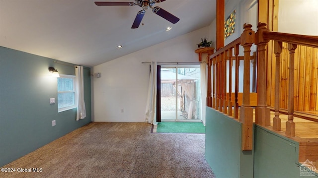 interior space featuring carpet flooring, vaulted ceiling, and ceiling fan