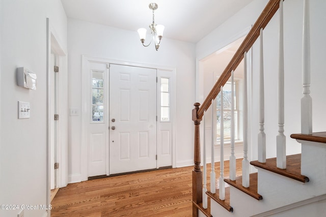 entryway with a notable chandelier and light hardwood / wood-style floors