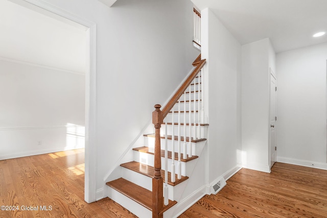 stairway featuring wood-type flooring