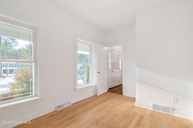 spare room featuring light hardwood / wood-style floors