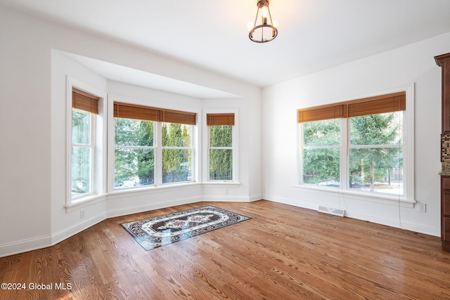 unfurnished room with hardwood / wood-style floors