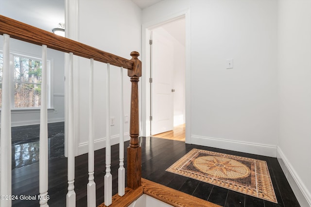 hallway with hardwood / wood-style flooring