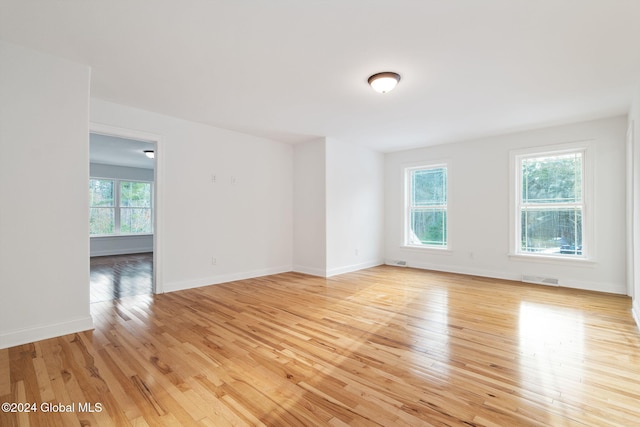 unfurnished room with light wood-type flooring