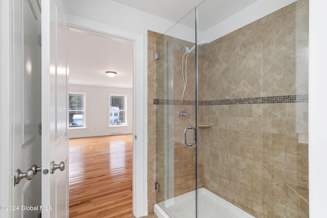 bathroom featuring a shower with door