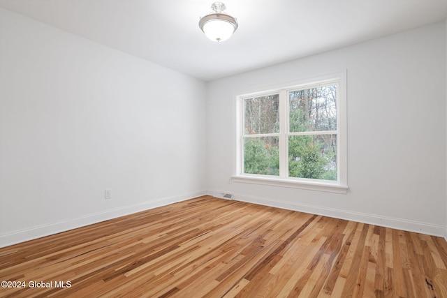 unfurnished room featuring hardwood / wood-style floors