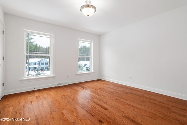 spare room featuring light hardwood / wood-style flooring