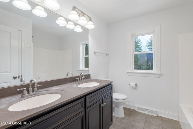 bathroom with tile patterned floors, vanity, and toilet