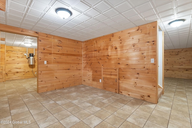 unfurnished room with wood walls