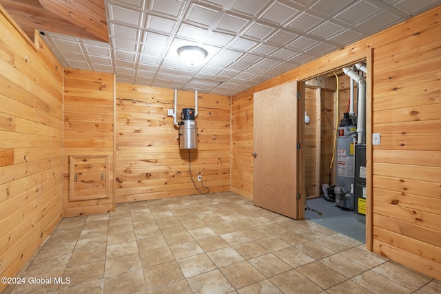 interior space featuring wood walls and gas water heater