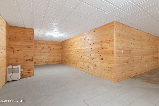 additional living space featuring wooden walls