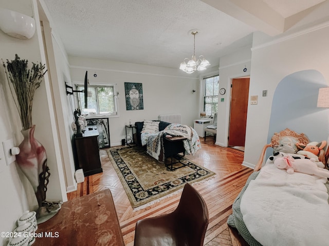 bedroom with radiator heating unit, light parquet flooring, a textured ceiling, and multiple windows