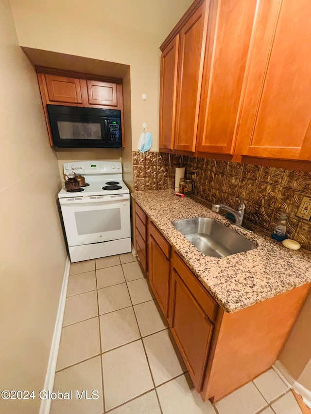 kitchen featuring sink, white electric stove, light tile patterned floors, tasteful backsplash, and light stone counters