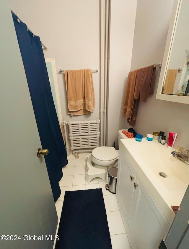 bathroom with toilet, tile patterned floors, and sink