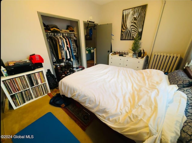 bedroom featuring carpet, radiator, and a closet