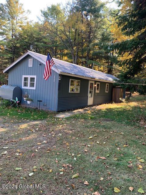 view of outbuilding featuring a lawn